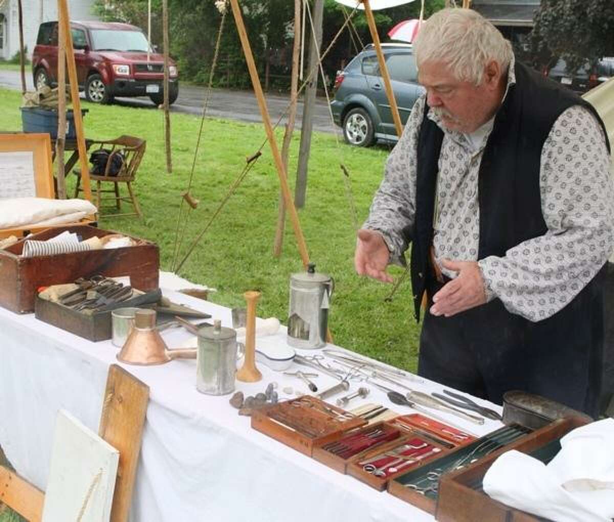 JOHN HAEGER @ONEIDAPHOTO ON TWITTER/ONEIDA DAILY Bill Mayers explains the tools and about the duties of a Civil War Surgeon on Friday, June 7, 2013 in Peterboro.