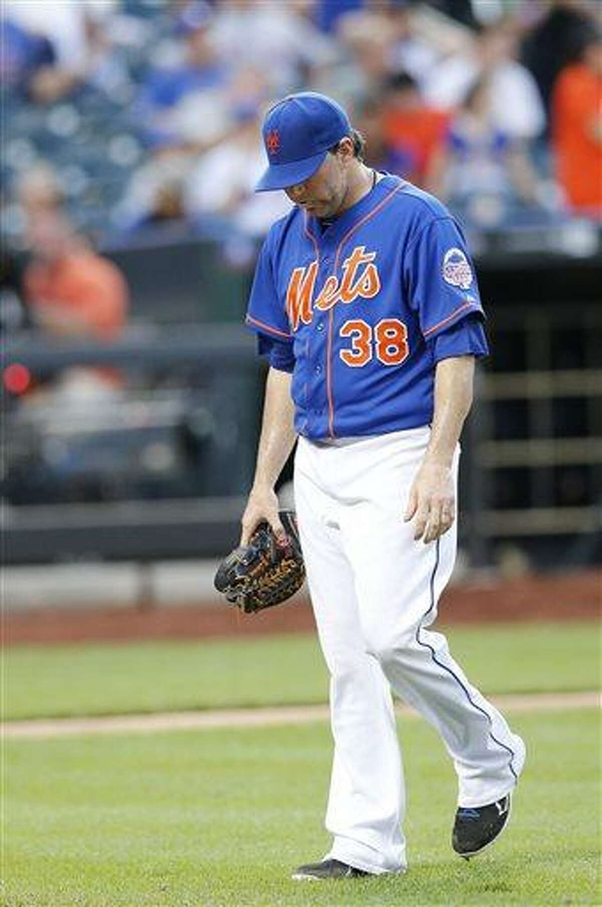 New York Mets pitcher Shaun Marcum (38) walks off the field after giving up a run in the 20th inning of 2-1 loss to the Miami Marlins during a baseball game at Citi Field in New York, Saturday, June 8, 2013. (AP Photo/Paul J. Bereswill)