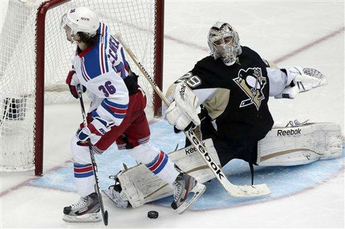 Pittsburgh Penguins goalie Marc-Andre Fleury (29) stops a shot by New York Rangers right wing Mats Zuccarello (36) during the shootout in an NHL hockey game in Pittsburgh Friday, April 5, 2013. The Penguins won 2-1. (AP Photo/Gene J. Puskar)