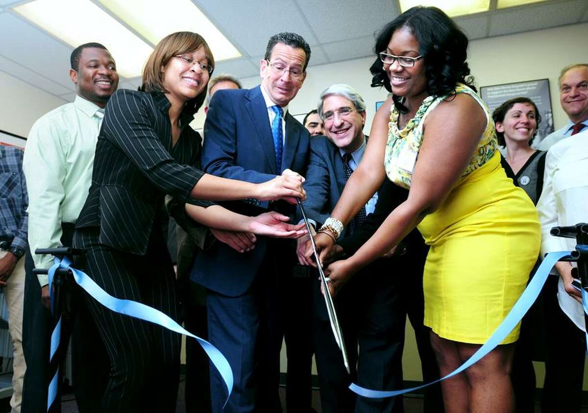 Left to right, New Haven Works graduate Osikhena Awudu watches New Haven Works member Angela Moore, Governor Dannel Malloy, Yale President-Elect Peter Salovey and New Haven Works volunteer Kamilia Norfleet cut the ceremonial ribbon at the grand opening of New Haven Works at 205 Whitney Ave. in New Haven on 6/5/2013.Photo by Arnold Gold/New Haven Register AG0501C