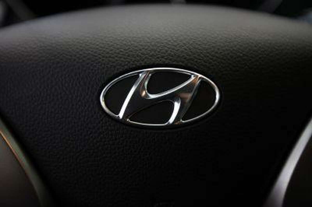 The logo of Hyundai Motor is seen on the steering wheel of a car at a Hyundai dealership in Seoul April 25, 2013.