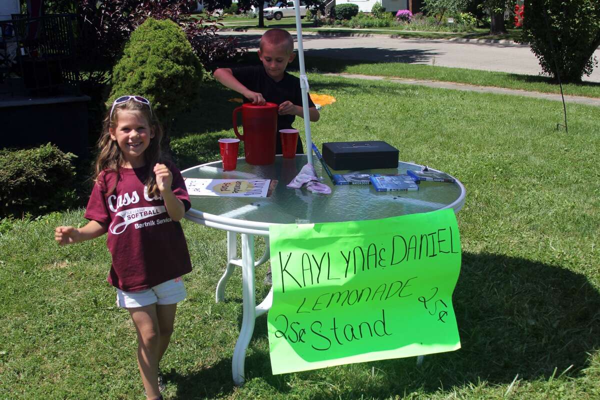 Local entrepreneurs Kaylyna Brown, 6, and Daniel Nickerson, 7, have been serving up tasty glasses of pink lemonade for the past week at their busy location off of North Port Crescent Street in Bad Axe. The two said they plan on offering refreshments on and off throughout the summer in order to save money up for toys.