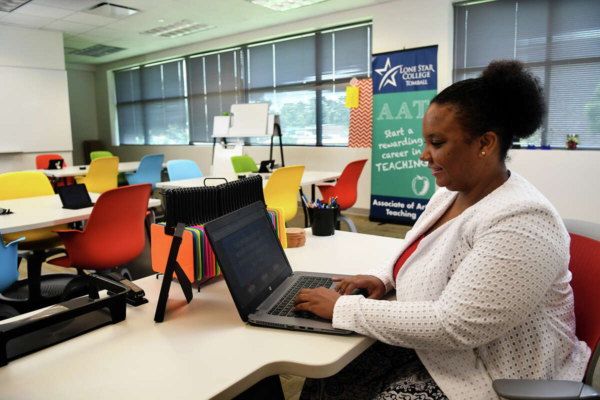Latoya Lewis, director of the Associates of Arts in Teaching program at Lone Star College Tomball (LSC-Tomball) and a teaching fellow and instructor in the TEaCH lab, works in a mock classroom created at the campus to help new teachers learn with new technology.