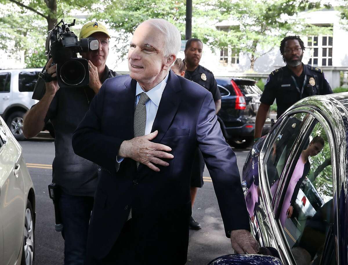 WASHINGTON, DC - JULY 25: Sen. John McCain (R-AZ) motions to well wishers as he gets into his car at the US Capitol July 25, 2017 in Washington, DC. McCain was recently diagnosed with brain cancer but returned on the day the Senate is holding a key procedural vote on U.S. President Donald Trump's effort to repeal and replace the Affordable Care Act. (Photo by Mark Wilson/Getty Images)