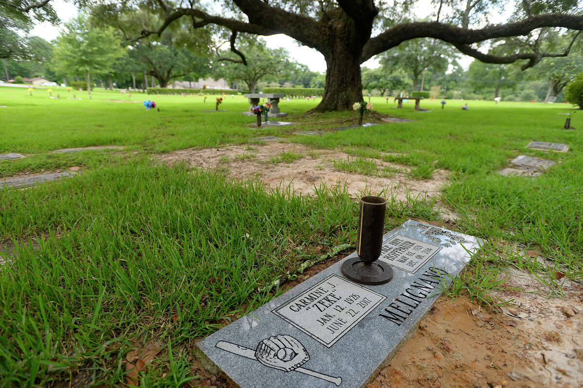The headstone for former baseball player Carmine "Zeke" Melignano and his wife, Syble, sits beneath an oak tree at Forest Lawn Memorial Park on Friday. Melignano, who died June 22, played for multiple minor league teams, including the Beaumont Exporters. He played for the Kansas City Blues in 1951 when Mickey Mantle was sent down to play for the team, according to his obituary. Melignano was called up to New York to pitch batting practice to Joe DiMaggio after the legendary Yankee returned from the Army Air Force. Photo taken Friday 7/21/17 Ryan Pelham/The Enterprise