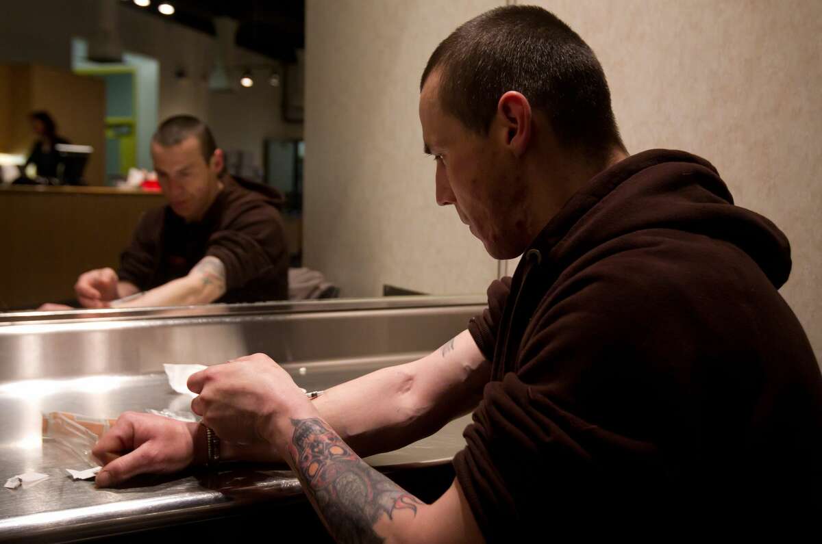 Richard Chenery injects heroin he bought on the street at the Insite safe injection clinic in Vancouver, B.C., on Wednesday May 11, 2011.
