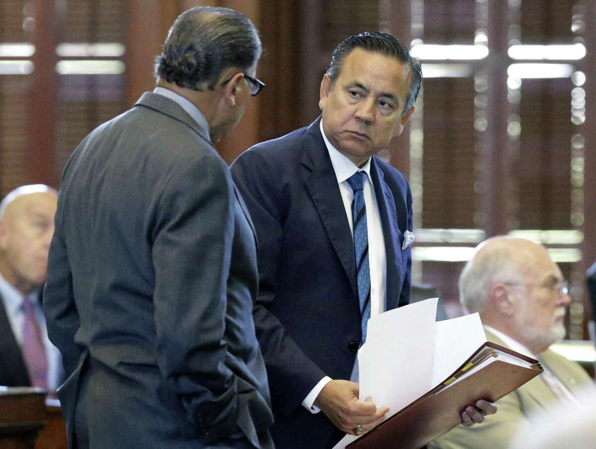 Senator Carlos Uresti talks with Senator Jose Rodriguez on the floor during the the special session on July 26, 2017.