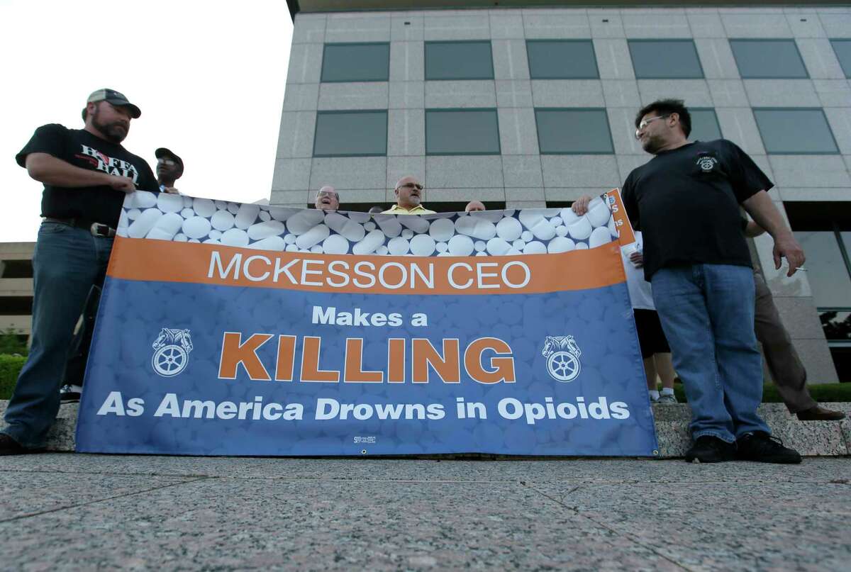 Teamsters hold a sign as they protest outside the McKesson Corp. shareholders meeting in Irving, Texas, Wednesday, July 26, 2017. McKesson Corp. is the largest U.S. distributor of prescription drugs. (AP Photo/LM Otero)