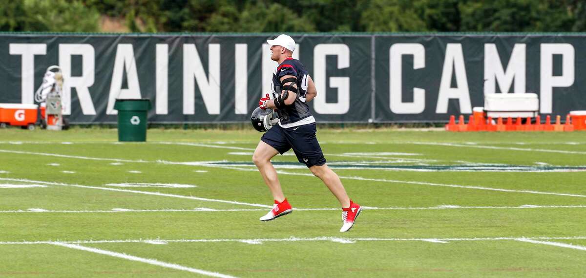 It's back to work for defensive star J.J. Watt as he trots onto the field for the first day of camp Wednesday in White Sulphur Springs, W.Va.