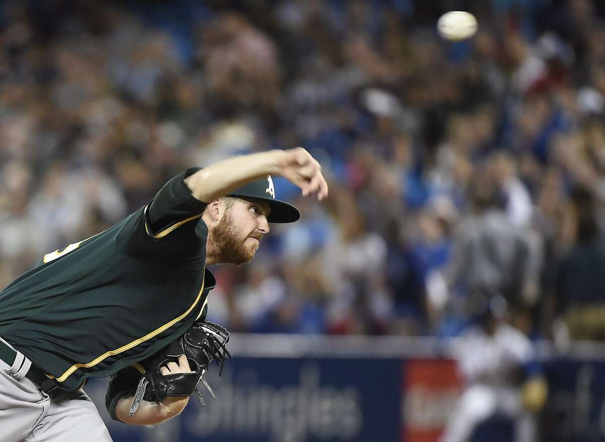 Oakland Athletics starting pitcher Paul Blackburn throws to a Toronto Blue Jays batter during the first inning of a baseball game Wednesday, July 26, 2017, in Toronto. (Nathan Denette/The Canadian Press via AP)