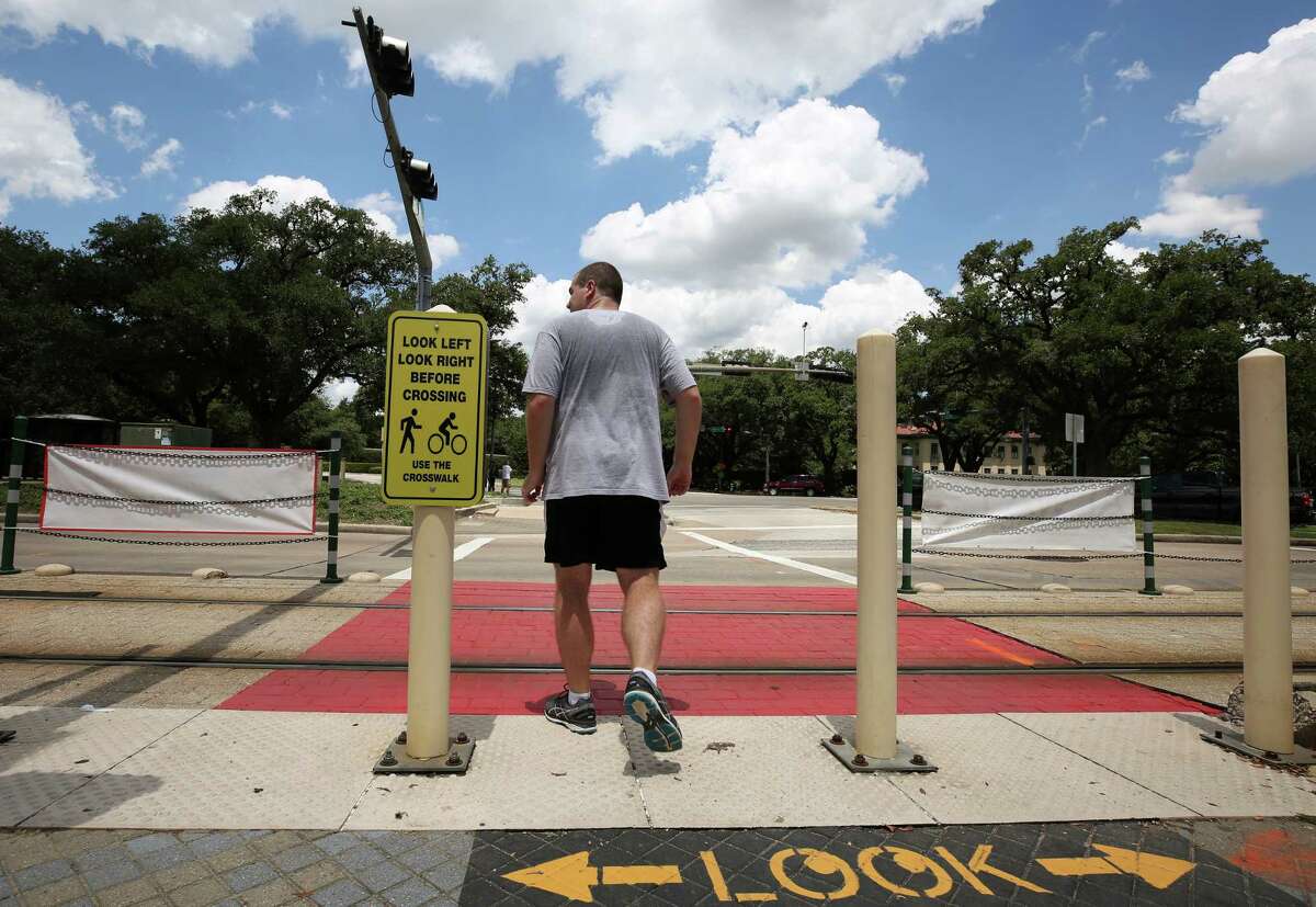 Metropolitan Transit Authority, Rice University, and the City of Houston have collaborated to make the crosswalk at the Hermann Park / Rice train stop safer, adding signs and painting the train tracks sections red, seen on July 26.