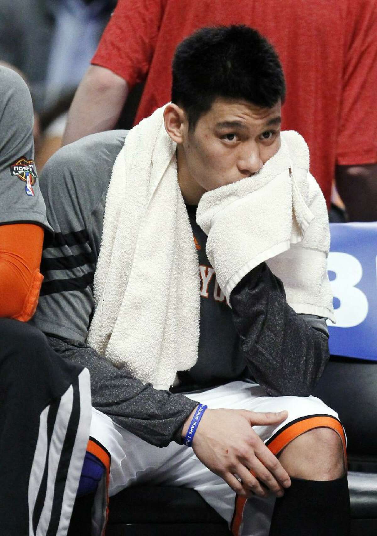 ASSOCIATED PRESS In this March 12 file photo, New York Knicks guard Jeremy Lin sits on the bench during the first half of a game against the Chicago Bulls in Chicago. Lin is having left knee surgery and will miss six weeks, likely ending his amazing breakthrough season. The team said Saturday that the point guard had an MRI exam this week that revealed a small, chronic meniscus tear.