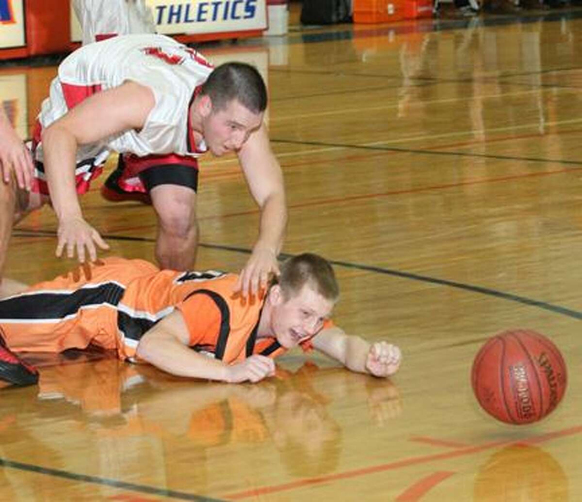 Dispatch Staff Photo by JOHN HAEGER (Twitter: @OneidaPhoto)VVS' Alex Saville (11) and Mohawk's Connor Schultz (24) dive for a loose ball in the first half of their game during the 13th Annual Alliance Bank Oneida Sports Boosters Basketball Shootout on Friday, Nov. 30, 2012 in Oneida.