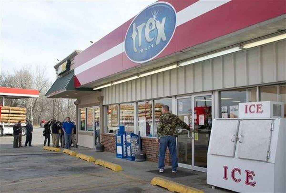 A customer enters Trex Mart as members of the news media gather in Dearborn, Mo., Thursday, Nov. 29, 2012. Trex Mart sold one of last night's winning Powerball tickets. (AP Photo/Orlin Wagner)