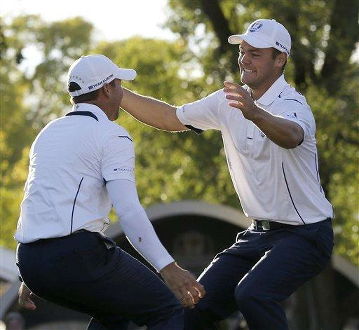 Europe's Martin Kaymer leaps into the arms of teammate Sergio Garcia after winning the Ryder Cup PGA golf tournament Sunday, Sept. 30, 2012, at the Medinah Country Club in Medinah, Ill. (AP Photo/David J. Phillip)
