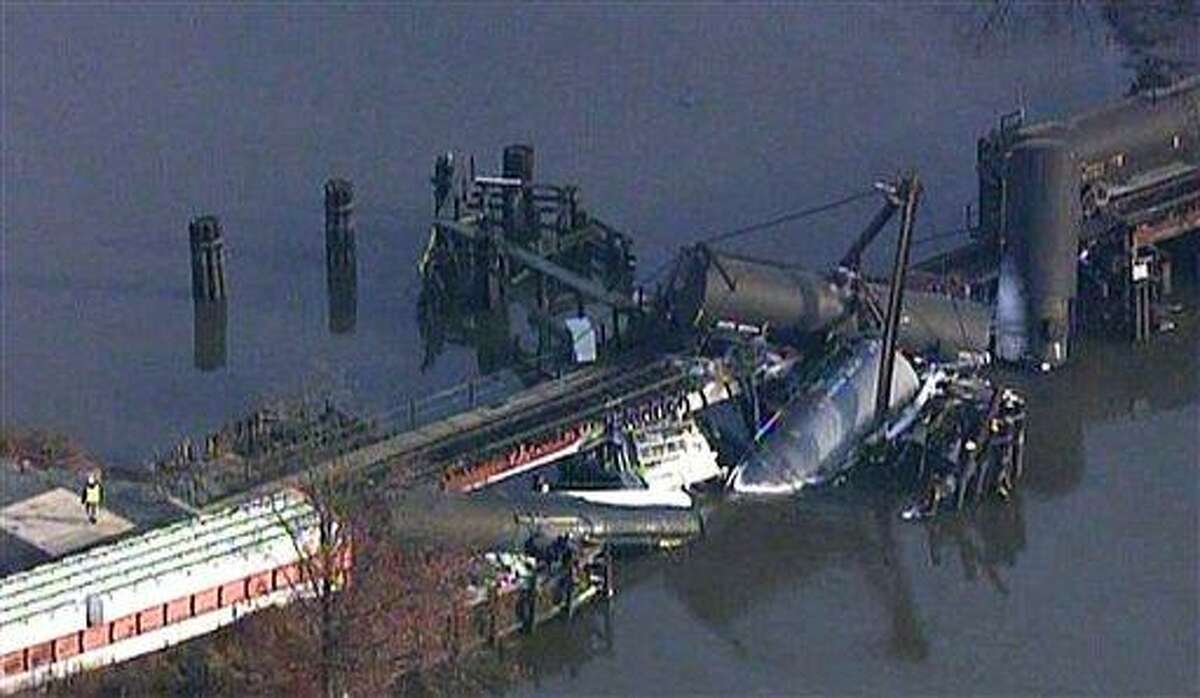 In this frame grab from video provided by WTXF Fox Philadelphia, crews work the scene where a freight train carrying hazardous chemicals derailed over Mantua Creek, Friday, Nov. 30, 2012, in Paulsboro, N.J. At least two tanker cars toppled into the creek causing a leak of hazardous vinyl chloride into the air Friday. Dozens of people went to a hospital complaining of breathing problems. (AP Photo/WTXF Fox Philadelphia)