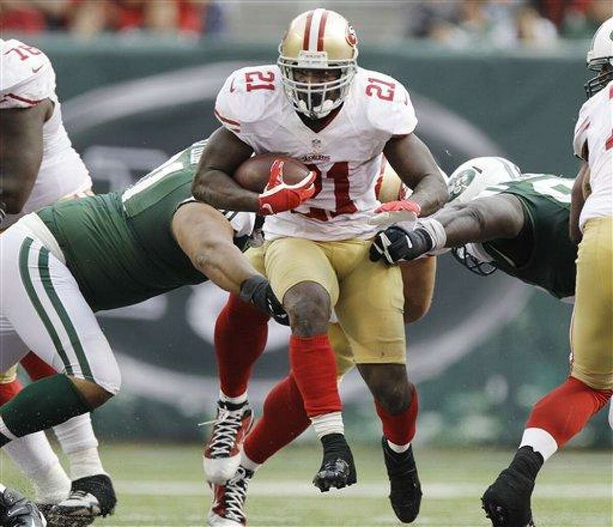 San Francisco 49ers running back Frank Gore (21) breaks through the line of scrimage during the second half of an NFL football game against the New York Jets Sunday, Sept. 30, 2012, in East Rutherford, N.J. (AP Photo/Kathy Willens)