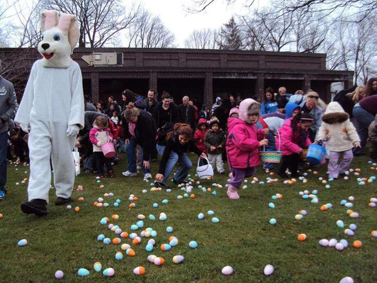RICKY CAMPBELL/ Register Citizen Kids rush after Easter eggs strewn across the grass at Coe Memorial Park Saturday, hoping to gather as many as possible. The annual Easter egg hunt, sponsored by the Torrington Parks and Recreation Department, drew hundreds of children and their families to the downtown location.