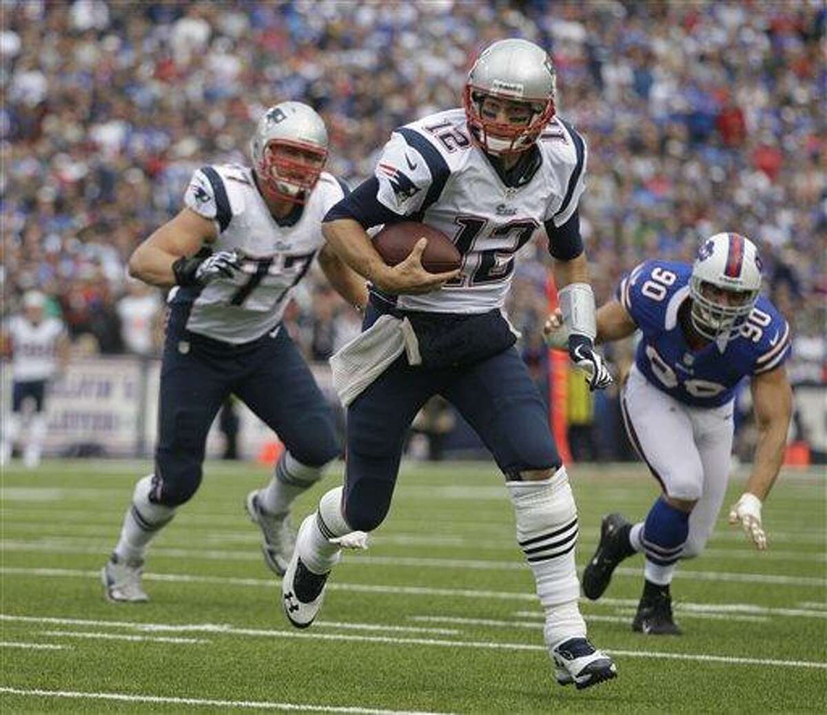 New England Patriots' Tom Brady runs for a touchdown against the Buffalo Bills during the second half of an NFL football game in Orchard Park, N.Y., Sunday, Sept. 30, 2012. (AP Photo/Gary Wiepert)