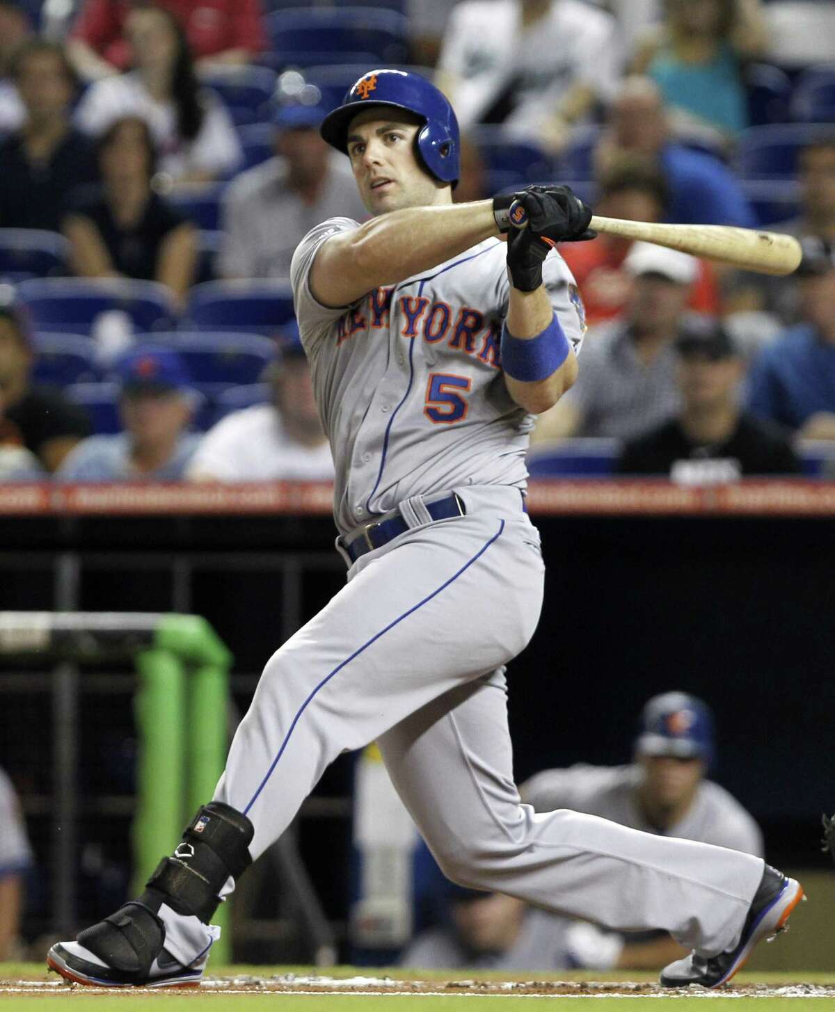 FILE - In this Oct. 2, 2012 file photo, New York Mets' David Wright follows through against the Miami Marlins during a baseball game in Miami. WFAN radio is reporting Friday, Nov. 30, 2012, that Wright and the New York Mets have agreed to a $138 million, eight-year contract that would be the richest in franchise history. (AP Photo/Alan Diaz, File)
