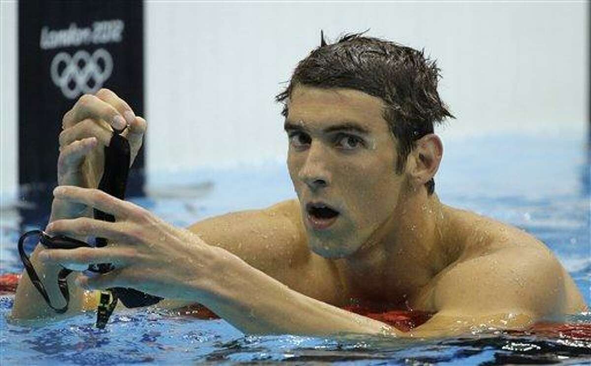 United States' Michael Phelps reacts after winning silver in the men's 200-meter butterfly swimming final at the Aquatics Centre in the Olympic Park during the 2012 Summer Olympics in London, Tuesday, July 31, 2012. (AP Photo/Matt Slocum)