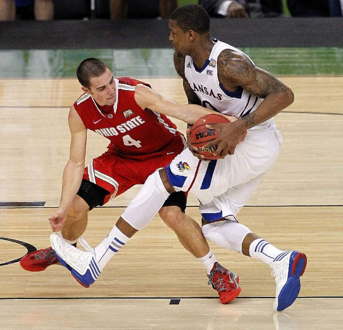 ASSOCIATED PRESS Kansas forward Thomas Robinson drives against Ohio State guard Aaron Craft (4) during the second half of an NCAA Final Four semifinal college game Saturday in New Orleans. The Jayhawks won 64-62.