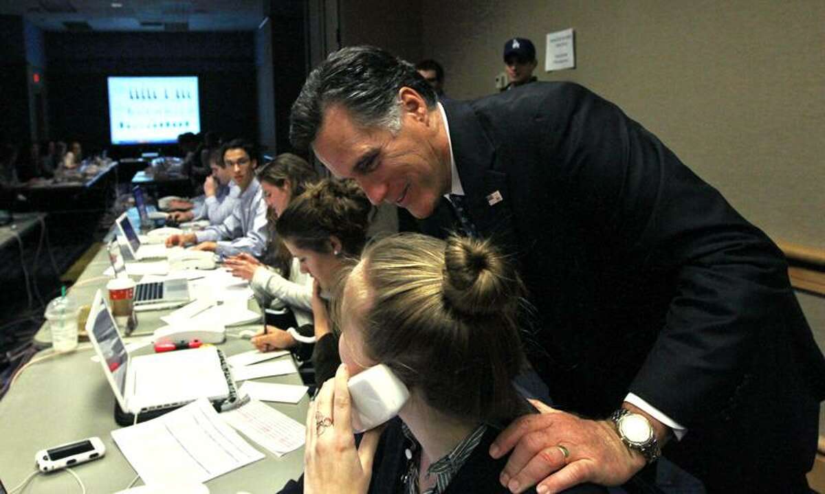 Republican presidential candidate, former Massachusetts Gov. Mitt Romney, visits with campaign workers in his "War Room" with advisers during the Florida primary election at the Tampa Convention Center in Tampa, Fla., Tuesday. Associated Press