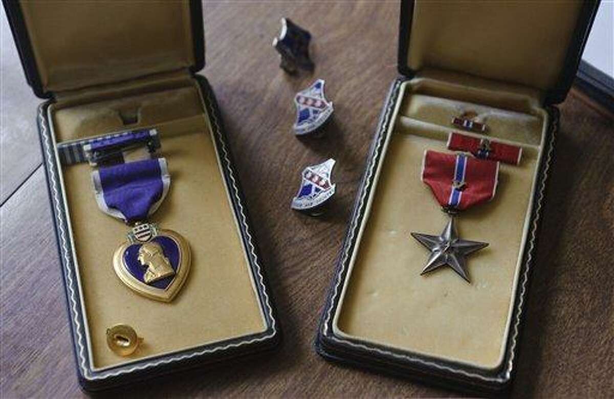 This July photo from New Britain, Conn., shows the Purple Heart and Bronze Star that were posthumously awarded to Cpl. Nicholas DeSimone, Jr., who went missing while serving in Korea on July 13, 1953. While helping her father organize his New Britain home, Lana Ogrodnik of Waterbury, Conn., found a stack of letters from Nicholas. (AP Photo/Jim Shannon Republican-American)