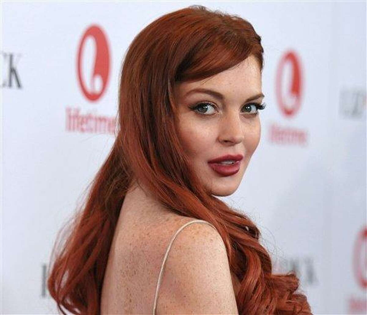 Lindsay Lohan attends a dinner celebrating the premiere of "Liz & Dick" at the Beverly Hills Hotel in Beverly Hills, Calif. Lohan is under arrest and charged with third-degree assault Thursday after police say she hit a woman during an argument at a New York City nightclub. Photo by John Shearer/Invision/AP