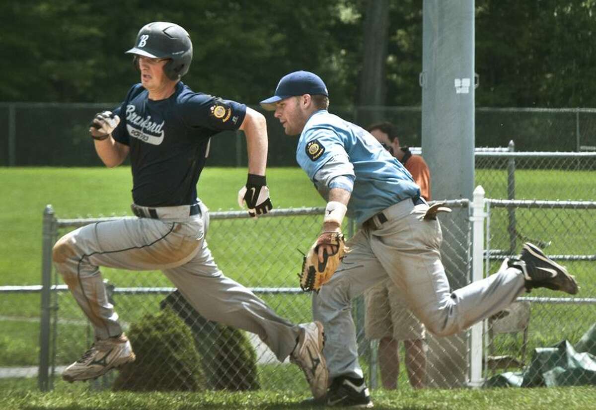 Sports--Branford's Michael Cattaruzza tries to out run Milford 3rd baseman Ed Michaud to score in the 7th inning of the American Legion Playoff game. Branford unsuccessfully attempted a double steal. Cattaruzza was tagged out. Melanie Sytengel/Register