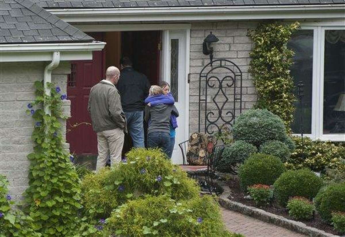 Visitors arrive at the home of Jeffrey Giuliano in New Fairfield, Conn., Friday. Giuliano fatally shot a masked teenager in self-defense during what appeared to be an attempted burglary early Thursday morning, then discovered that he had killed his son, Tyler, state police said. (AP Photo/Jessica Hill)