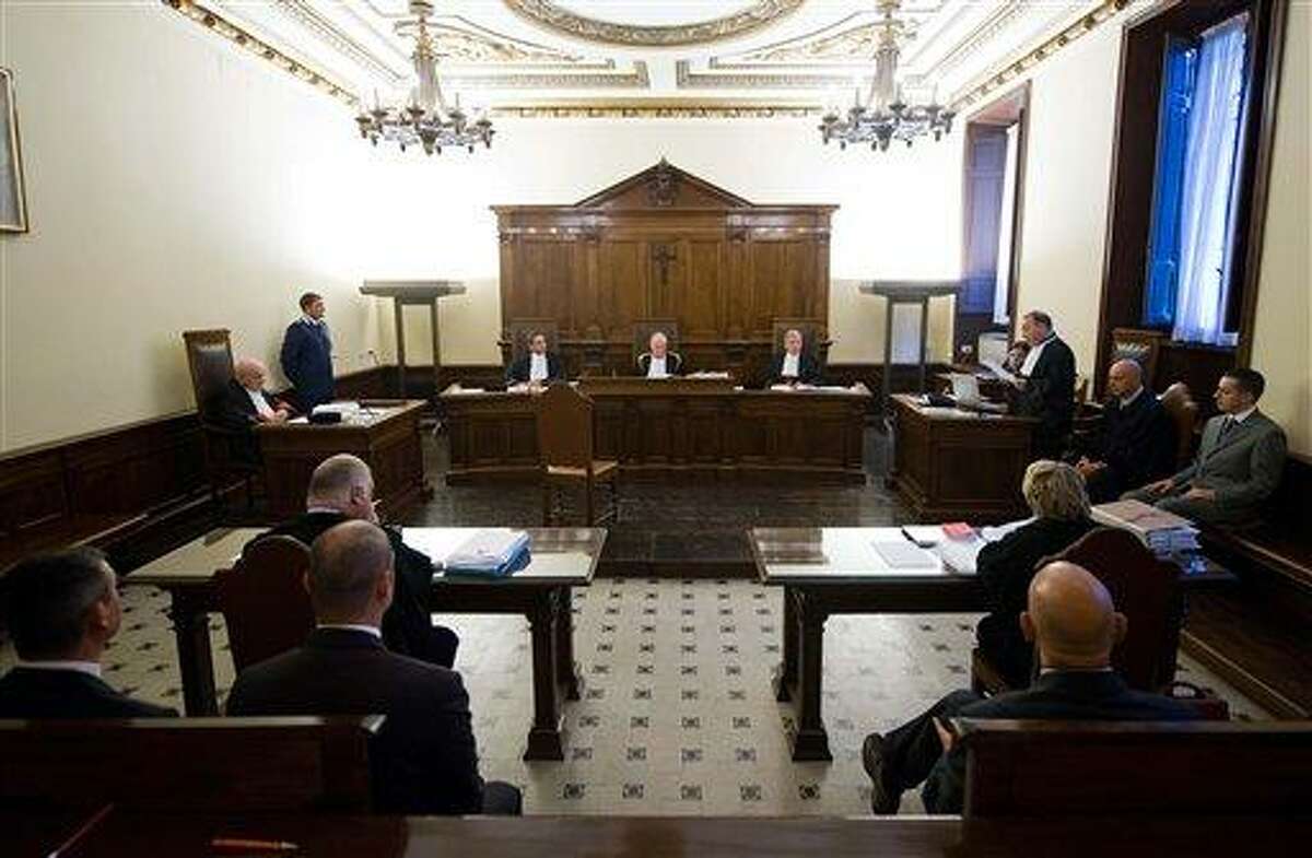 In this photo released by the Vatican paper L'Osservatore Romano, pope's butler Paolo Gabriele, lower right corner, sits in the wood-trimmed courtroom of the Vatican tribunal, at the Vatican, Saturday. The Vatican opened the public trial Saturday of the pope's butler for allegedly stealing and leaking papal correspondence to a journalist, the most embarrassing scandal of Pope Benedict XVI's papacy. The butler has already confessed, saying he acted to shed light on what he called "evil and corruption" in the church, and asked to be pardoned by the pope, something Vatican watchers say is a given if he is convicted. (AP Photo/L'Osservatore Romano)