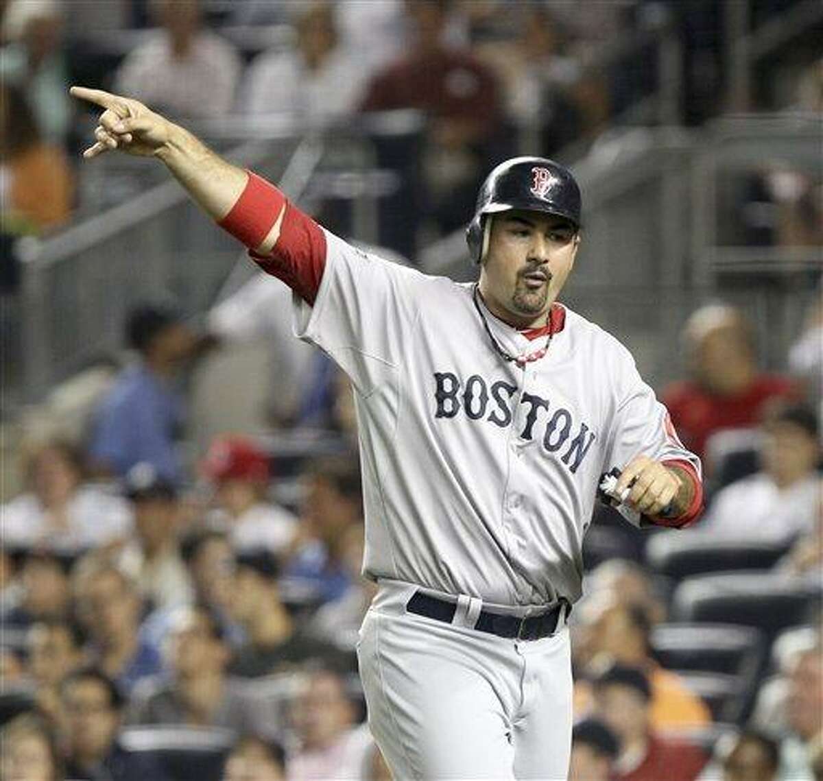 Boston Red Sox's Adrian Gonzalez reacts after scoring on a double by Ryan Sweeney during the second inning of a baseball game against the New York Yankees at Yankee Stadium in New York, Sunday, July 29, 2012. (AP Photo/Seth Wenig)