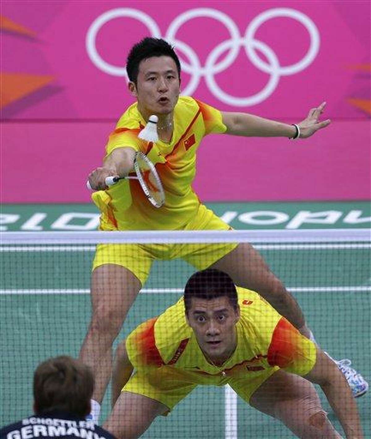 China's Cai Yun, top left, and Fu Haifeng play against Germany's Johannes Schoettler, foreground, and Ingo Kindervater, unseen, at a men's doubles badminton match of the 2012 Summer Olympics, Sunday, July 29, 2012, in London. (AP Photo/Saurabh Das)