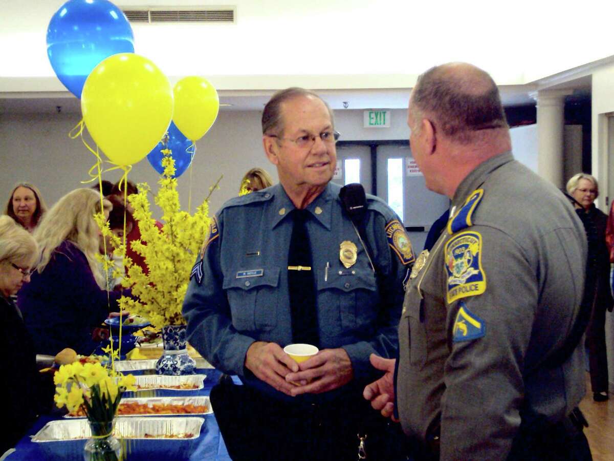 RICKY CAMPBELL/Register Citizen Litchfield Cpl. Roger "Dodgie" Doyle greets Litchfield Resident State Trooper First Class James Holm during Doyle's farewell luncheon Friday at Bantam Fire Company. The lunch, which was attended by Litchfield town employees, was on Doyle's last day before retirement. He served 46 years policing and helping his hometown.