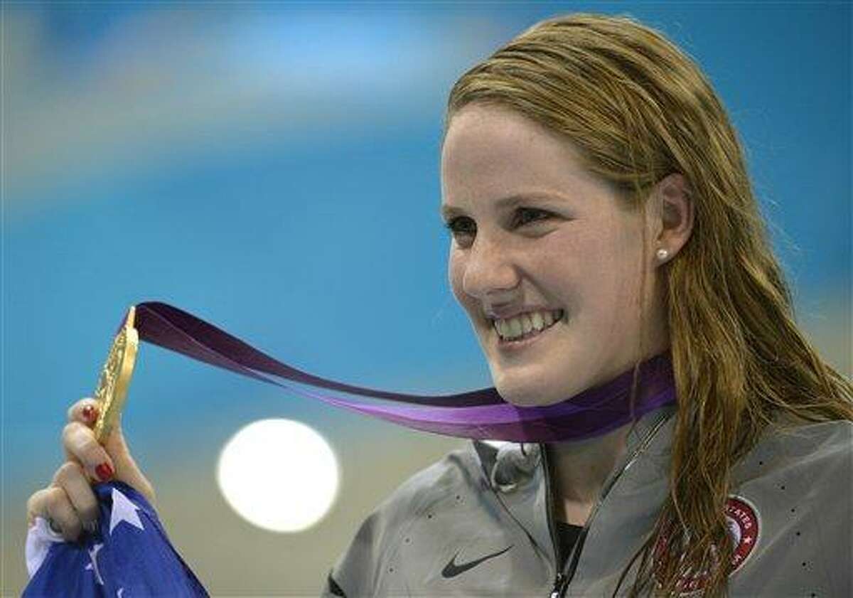 United States' Missy Franklin poses with her gold medal for the women's 100-meter backstroke swimming final at the Aquatics Centre in the Olympic Park during the 2012 Summer Olympics in London, Monday, July 30, 2012. (AP Photo/Mark J. Terrill)
