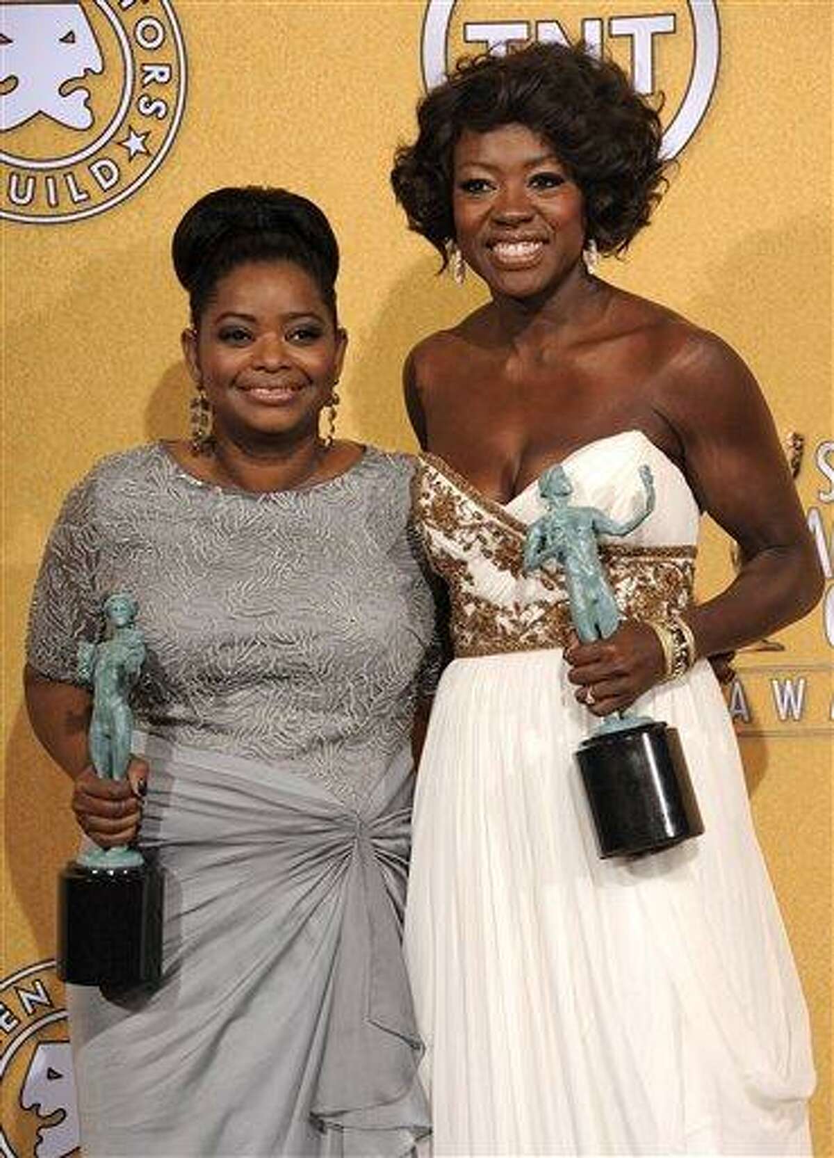Octavia Spencer, winner of award for outstanding performance by a female actor in a supporting role for "The Help," left, and Viola Davis, winner of the award for outstanding performance by a female actor in a leading role for "The Help," pose backstage at the 18th Annual Screen Actors Guild Awards on Sunday Jan. 29, 2012 in Los Angeles.