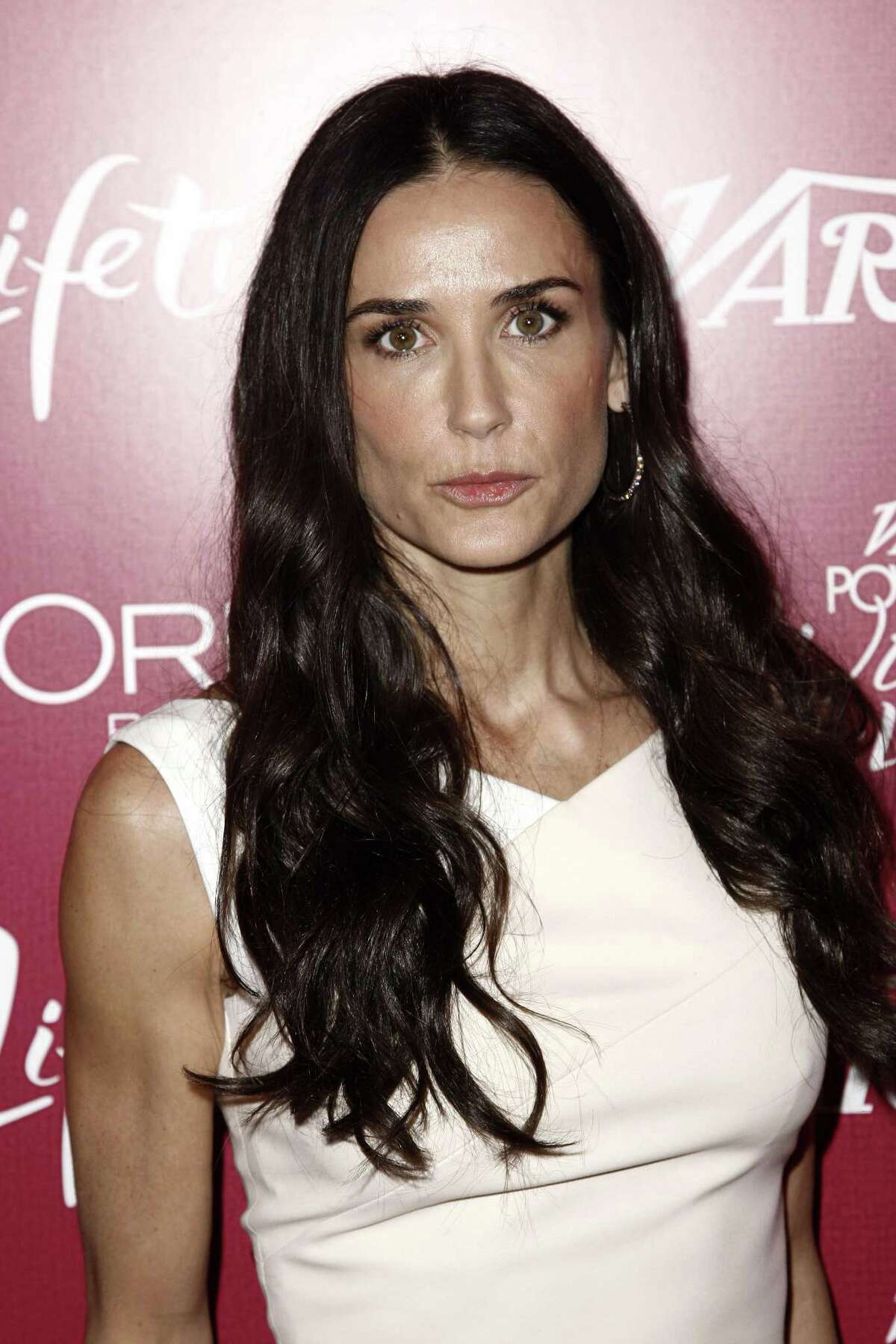 Demi Moore arrives at Variety's 3rd Annual Power of Women Luncheon in Beverly Hills, Calif., in this Sept. 23, 2011 photo. A 911 recording released Friday Jan. 27, 2012 by Los Angeles fire officials revealed frantic efforts by friends of Demi Moore to get help for the actress who was convulsing as they gathered around her and tried to comfort her. Moore was "semi-conscious, barely," according to a female caller on the recording. (AP Photo/Matt Sayles)