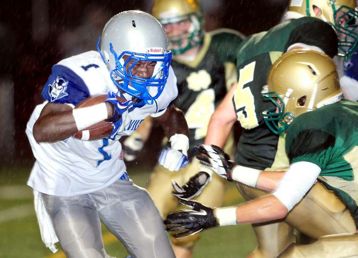 Ervin Philips (left) of West Haven runs for a touchdown in the first quarter against Notre Dame on 9/28/2012. Photo by Arnold Gold/New Haven Register AG0464B