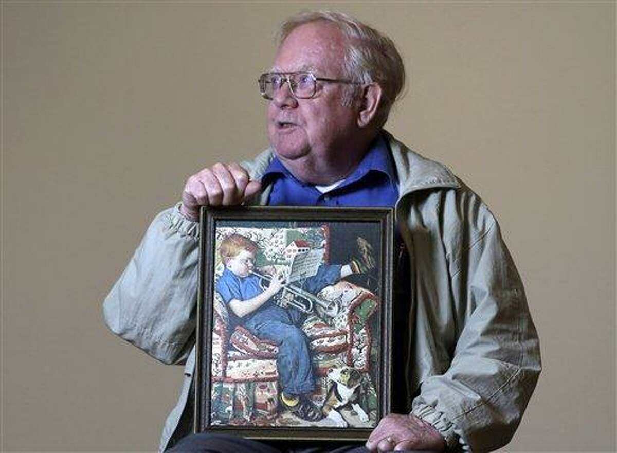 Tom Paquin of North Bennington, Vt., poses with a 1950 Saturday Evening Post illustration by Norman Rockwell for which he modeled at the Bennington Museum on Friday, in Bennington, Vt. (AP Photo)