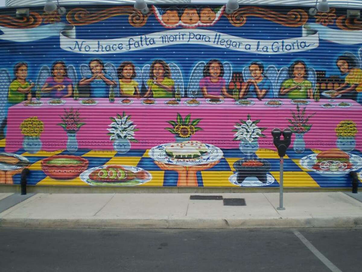 Stephen Fries photo: The back of La Gloria restaurant is a mural by local artist Claudio Aguillon, depicting the love of family and food in Mexico and the U.S. "You don't have to die to get to heaven" is the translation of the text in the banner.