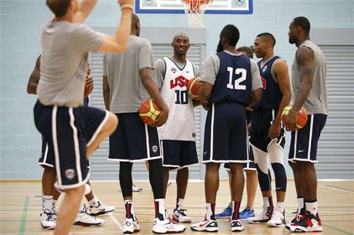 United States players, from right, LeBron James, Russell Westbrook, James Harden (12), Kobe Bryant (10) and Kevin Durant gather for a men's team basketball practice at the 2012 Summer Olympics, Saturday, July 28, 2012, in London. (AP Photo/Jae C. Hong)