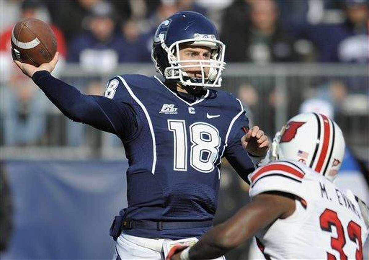 Connecticut's Johnny McEntee throws against Louisville's Mike Evans in the first half of an NCAA college football game at Rentschler Field in East Hartford, Conn., Saturday, Nov. 19, 2011. Louisville beat Connecticut 34-20. (AP Photo/Jessica Hill)