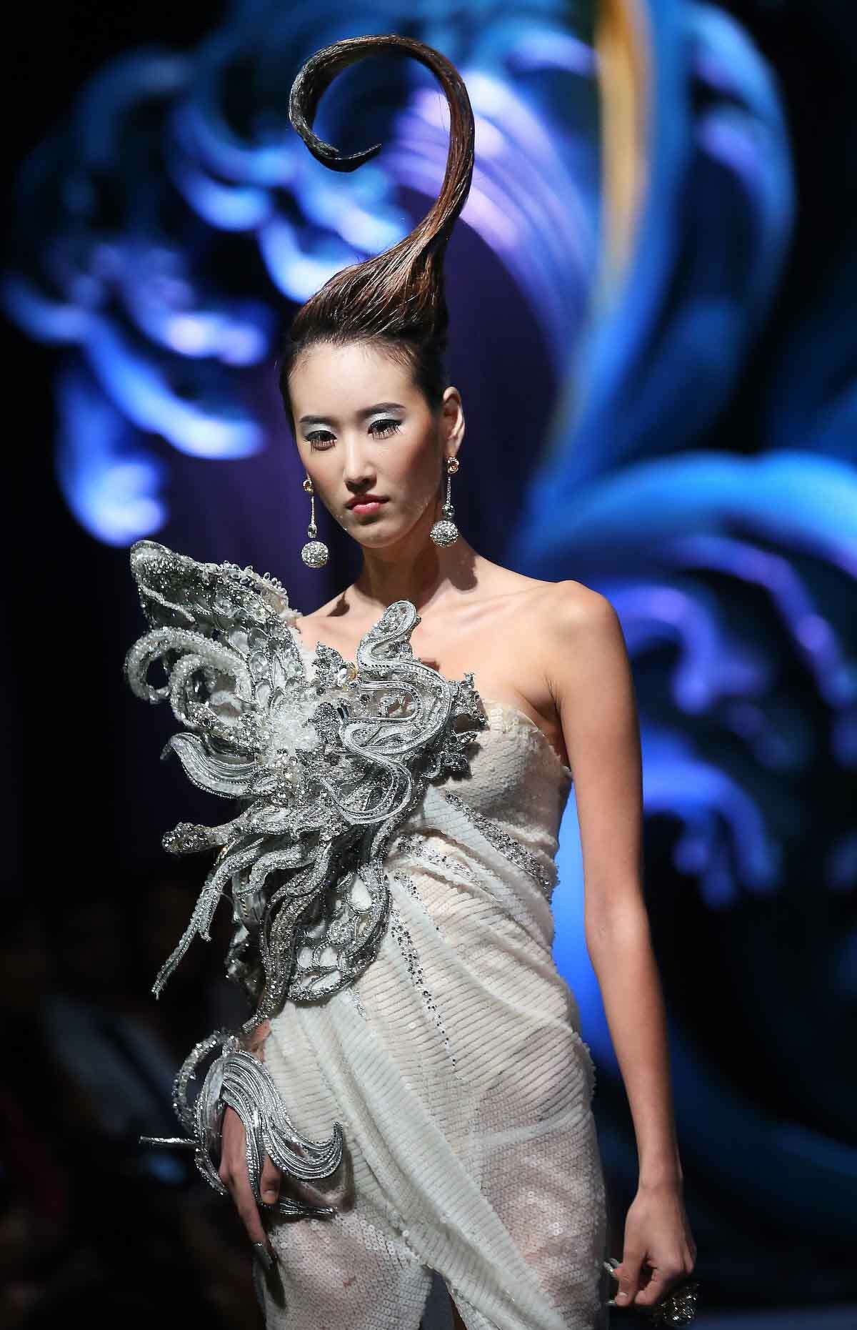 A model showcases a creation by Chinese designer Guo Pei on Tuesday Nov. 27, 2012, in Singapore during the Asian Couture 2012 Singapore fashion show. (AP Photo/Wong Maye-E)