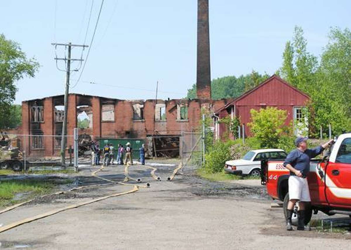 Viktoria Sundqvist I The Middletown PressHealth officials walk the scene of the fire at the Bevin Bell Factory in East Hampton on Sunday afternoon after a fire destroyed the building overnight.