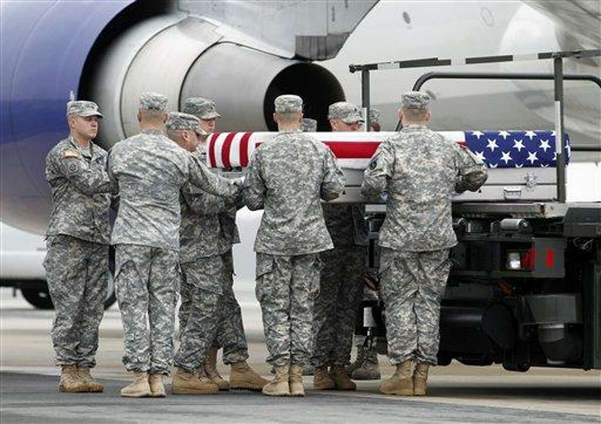 An Army carry team carries the transfer case containing the remains of Army Spc. Dennis P. Weichel Jr. of Providence, R.I., upon arrival at Dover Air Force Base, Del. The Department of Defense announced the death of Weichel Jr., who was supporting Operation Enduring Freedom in Afghanistan. Associated Press