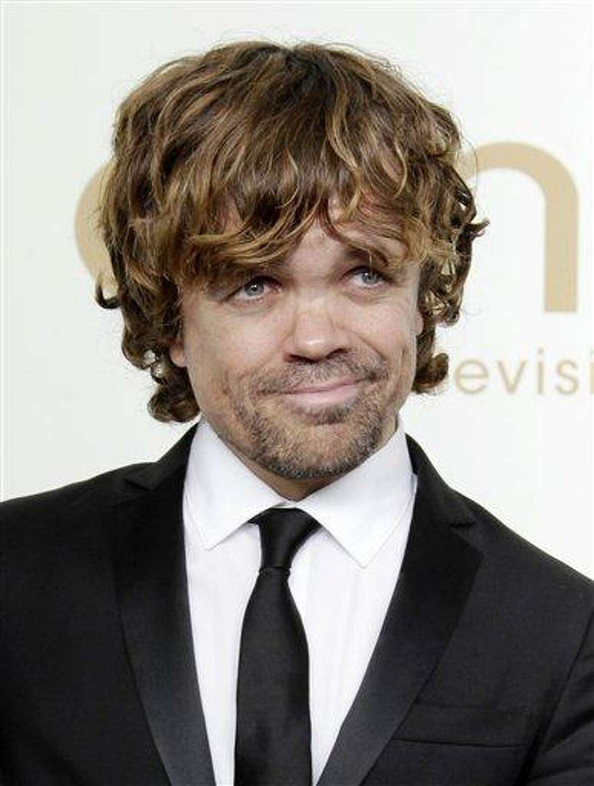 In this file photo, Peter Dinklage from the HBO series "Game of Thrones" poses backstage at the 63rd Primetime Emmy Awards in Los Angeles. Dinklage won the Emmy for best supporting actor in a drama series for his role as Tyrion Lannister. Dinklage, 43, who has been a vegetarian since he was 16, is the national spokesman for Farm Sanctuary's annual Walk for Farm Animals. He has filmed a YouTube video and will spend his off season promoting the group's campaign to change the way society views and treats farm animals. (AP)