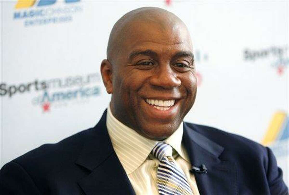 Basketball legend turned entrepreneur Magic Johnson tours the Sports Museum of America in New York in 2008. A group that includes former Lakers star Magic Johnson and longtime baseball executive Stan Kasten agreed Tuesday to buy the Los Angeles Dodgers from Frank McCourt for $2 billion. Associated Press
