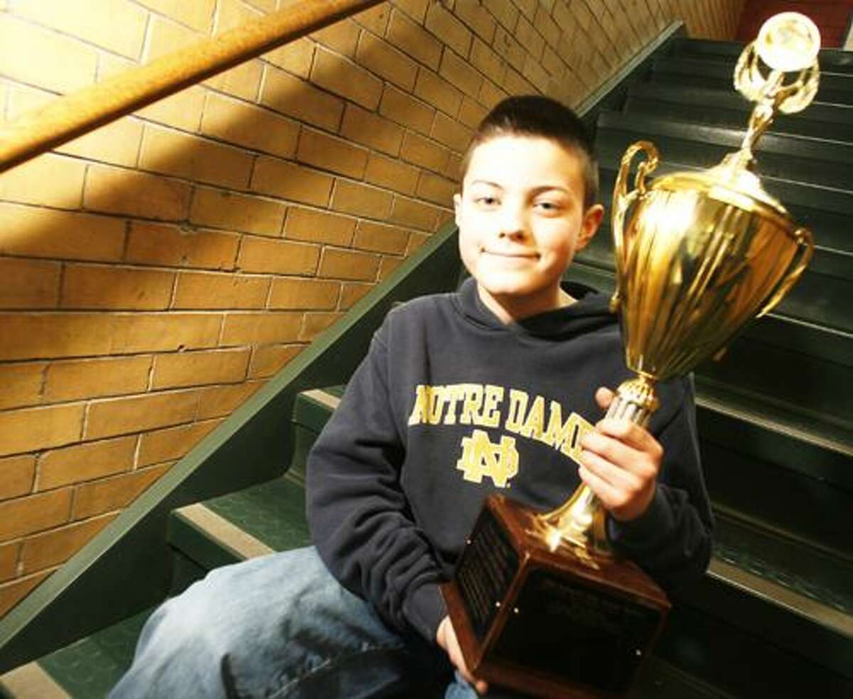 Photo by JOHN HAEGER (Twitter.com/OneidaPhoto) North Broad Street Elementary School fifth grader Steven Sayles poses with the Geography Bee trophy after he recently took first place against students at Durhamville Elementary School.