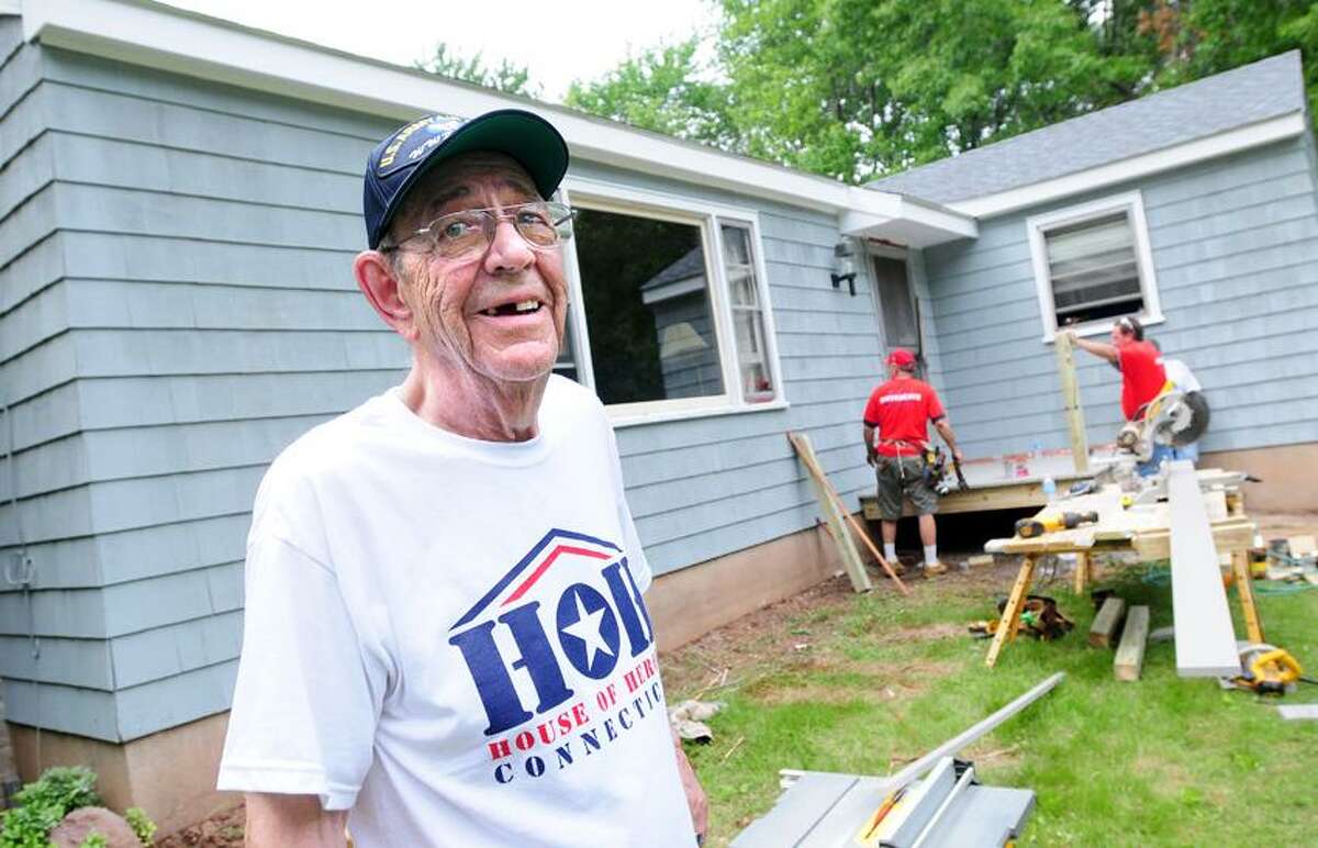 World War II veteran Fred Miller watches the renovations taking place at his home on Still Hill Rd. in Hamden by House of Heroes volunteers on 5/26/2012.Photo by Arnold Gold/New Haven Register AG0450C